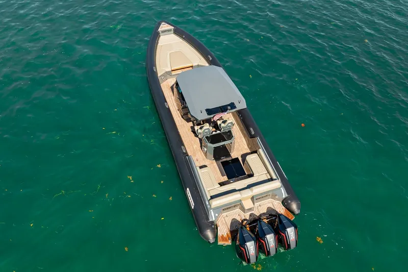 Slide: The Image of 2023 Skipper-BSK 38NC boat with triple engines on clear blue water. - 38