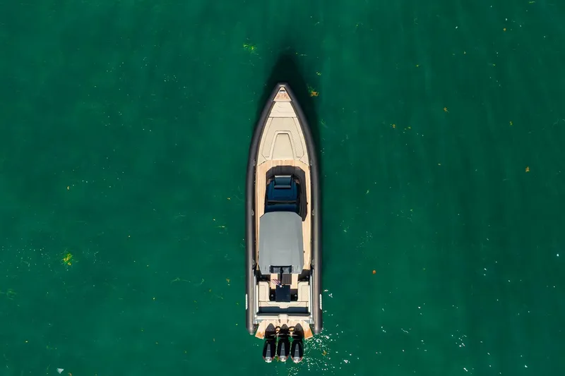 Slide: The Image of Aerial view of 2023 Skipper-BSK 38NC boat on clear green water. - 39