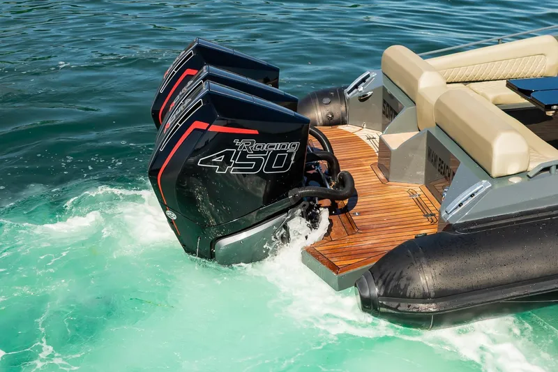 Slide: The Image of 2023 Skipper-BSK 38NC boat with dual Racing 450 engines on turquoise water. - 42