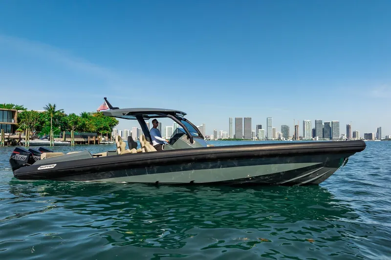 Slide: The Image of 2023 Skipper-BSK 38NC boat cruising near city skyline on a sunny day. - 47