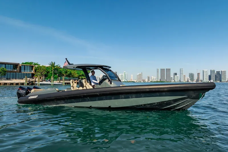 Slide: The Image of 2023 Skipper-BSK 38NC boat cruising near city skyline on a sunny day. - 48