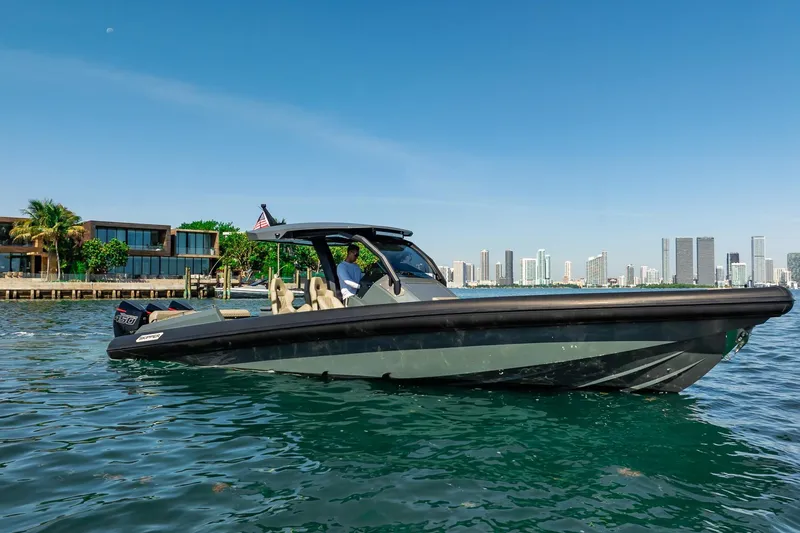 Slide: The Image of 2023 Skipper-BSK 38NC boat cruising near modern waterfront buildings. - 49