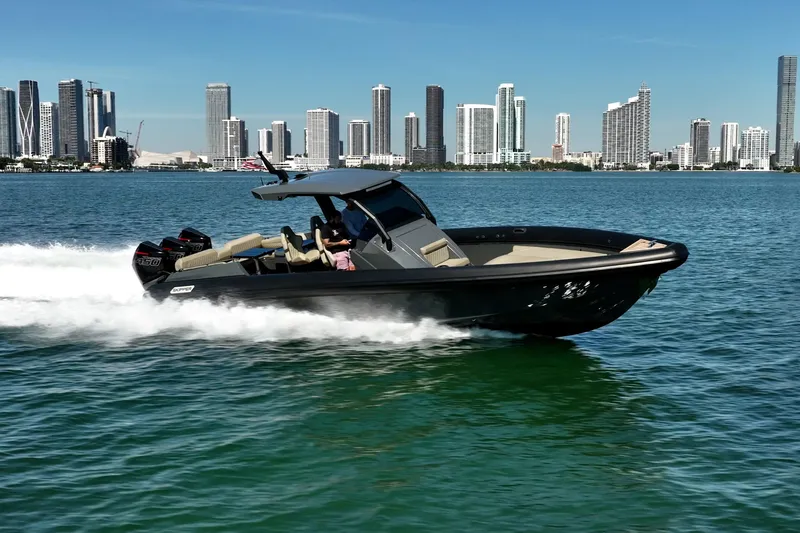 Slide: The Image of 2023 Skipper-BSK 38NC boat cruising on water with city skyline backdrop. - 5