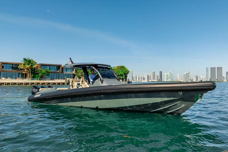 Slide: The Image of 2023 Skipper-BSK 38NC boat on water with city skyline background. - 50