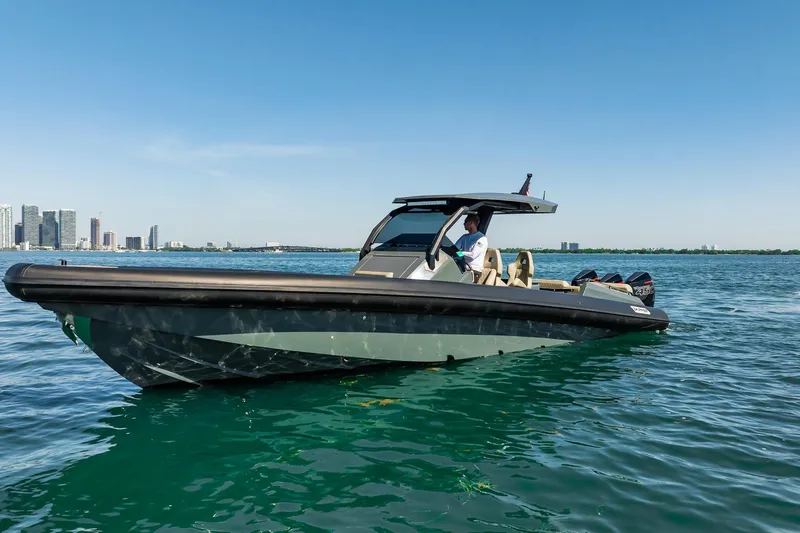 Slide: The Image of 2023 Skipper-BSK 38NC boat cruising on clear blue water near city skyline. - 54