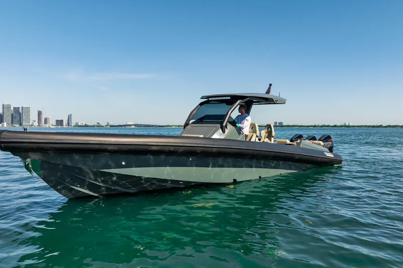 Slide: The Image of 2023 Skipper-BSK 38NC boat cruising on clear blue water near city skyline. - 55