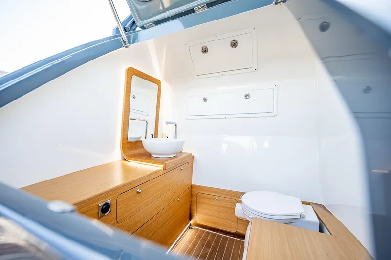 Slide: The Image of Modern bathroom interior on 2023 Skipper-BSK 38NC boat, featuring wooden cabinetry and sleek fixtures. - 59