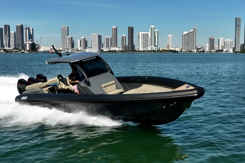Slide: The Image of 2023 Skipper-BSK 38NC boat cruising near city skyline on a sunny day. - 6