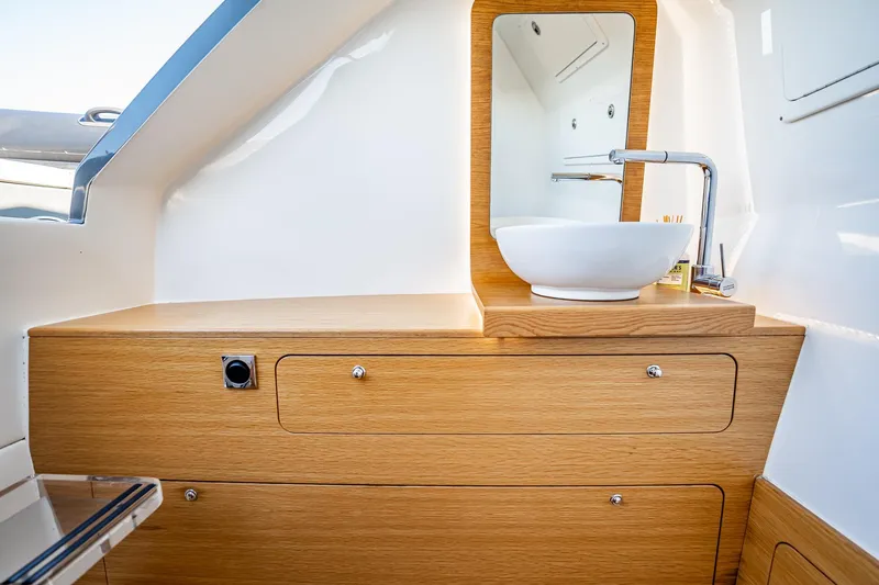 Slide: The Image of Modern bathroom vanity on 2023 Skipper-BSK 38NC yacht with wooden cabinetry and sleek sink. - 63