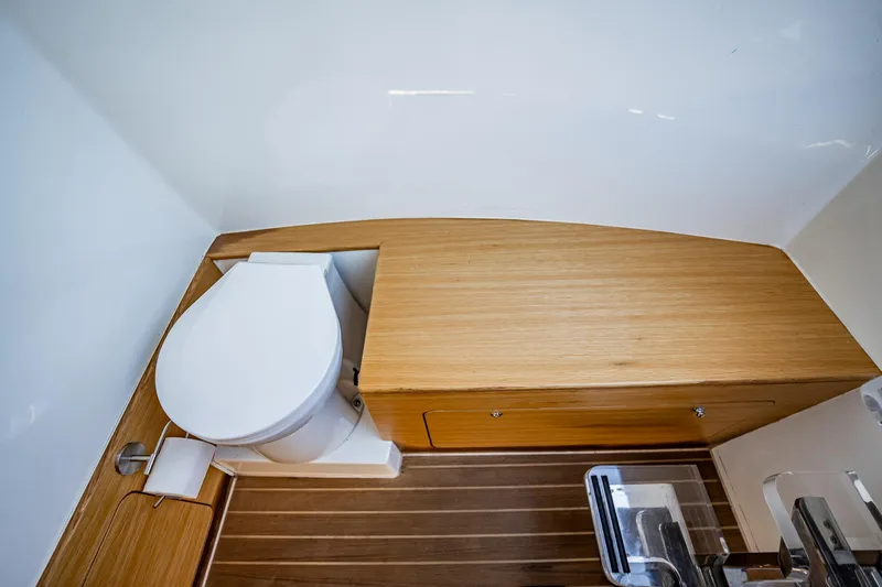 Slide: The Image of Modern boat bathroom with wooden accents, featuring a toilet and sleek design. Skipper-BSK 38NC, 2023 model. - 64