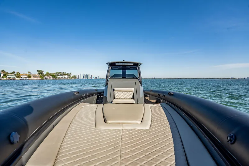 Slide: The Image of 2023 Skipper-BSK 38NC luxury boat on calm waters with city skyline. - 75