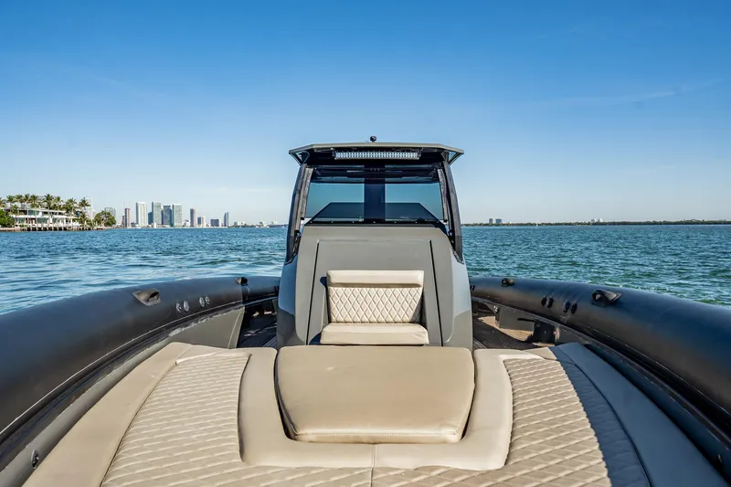 Slide: The Image of Luxury Skipper-BSK 38NC boat on water with city skyline in background, 2023 model. - 77