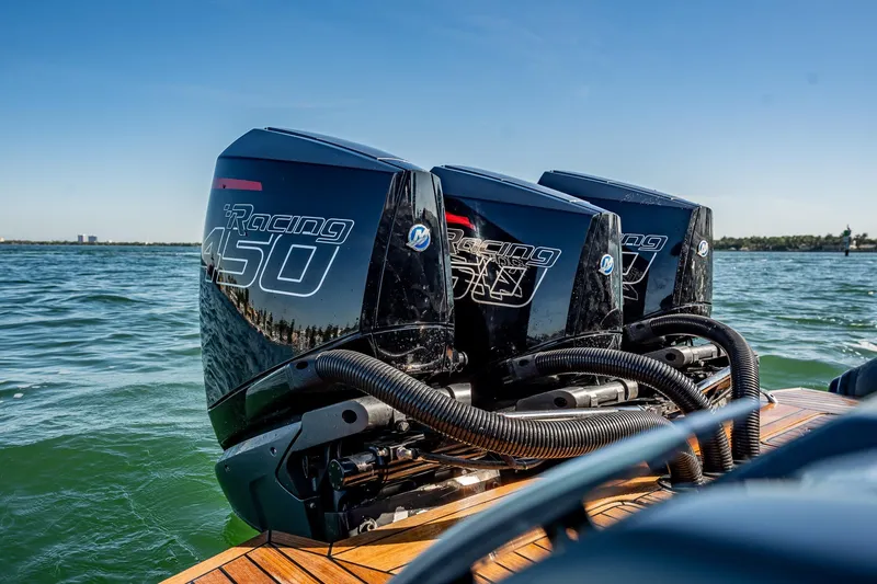 Slide: The Image of Triple Mercury Racing 450 engines on Skipper-BSK 38NC boat, 2023 model, on open water. - 79