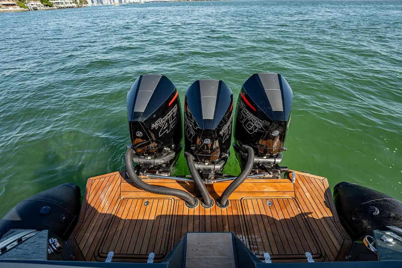 Slide: The Image of Triple outboard engines on a 2023 Skipper-BSK 38NC boat, cruising on open water. - 81