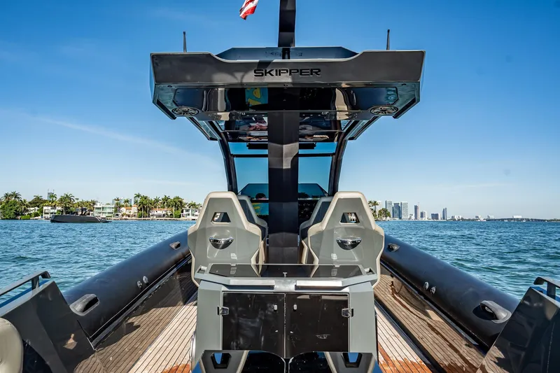 Slide: The Image of 2023 Skipper-BSK 38NC boat on water, city skyline in background. - 86