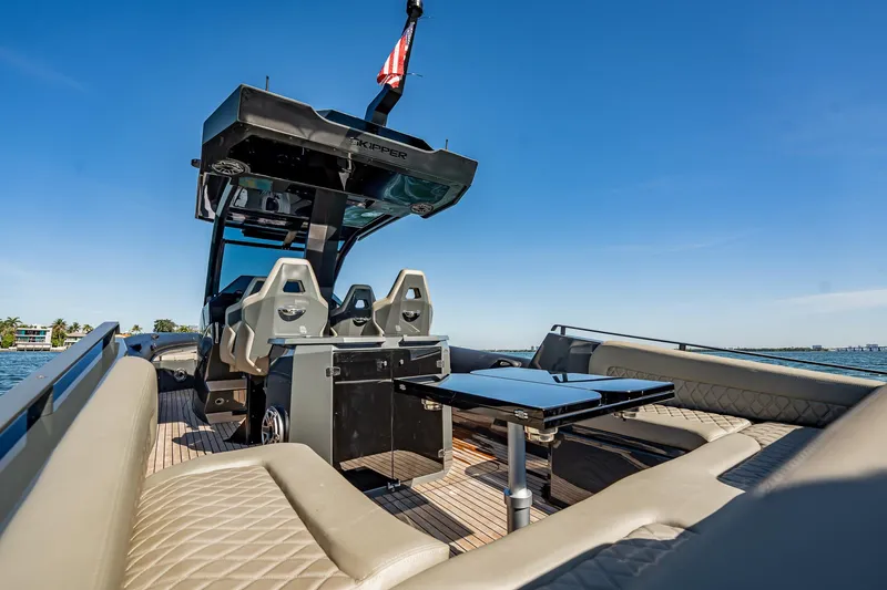 Slide: The Image of Luxurious 2023 Skipper-BSK 38NC boat interior with seating and table on a sunny day. - 87