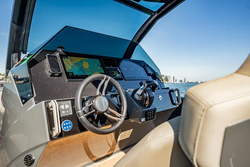 Slide: The Image of 2023 Skipper-BSK 38NC boat dashboard with navigation system and steering wheel. - 95