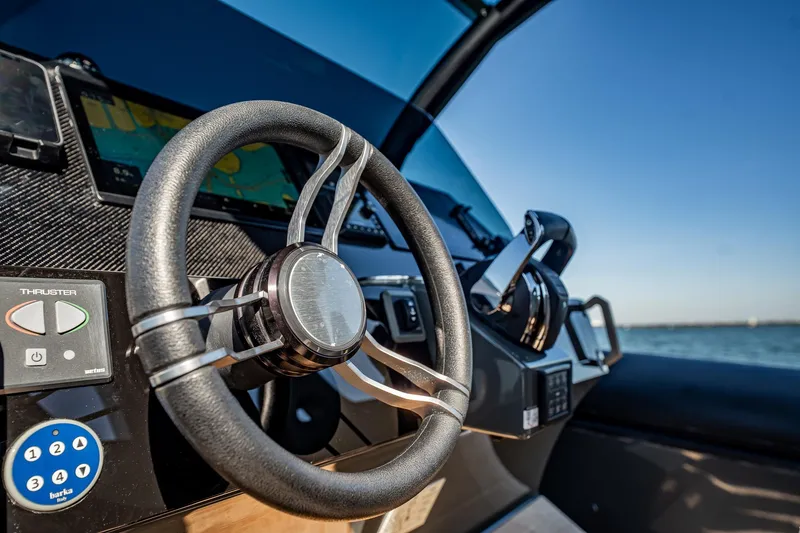 Slide: The Image of Steering wheel and controls of 2023 Skipper-BSK 38NC boat, with ocean view. - 97