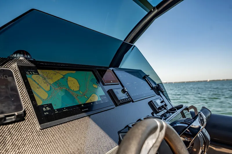 Slide: The Image of Cockpit of 2023 Skipper-BSK 38NC boat with navigation screens and steering wheel. - 98