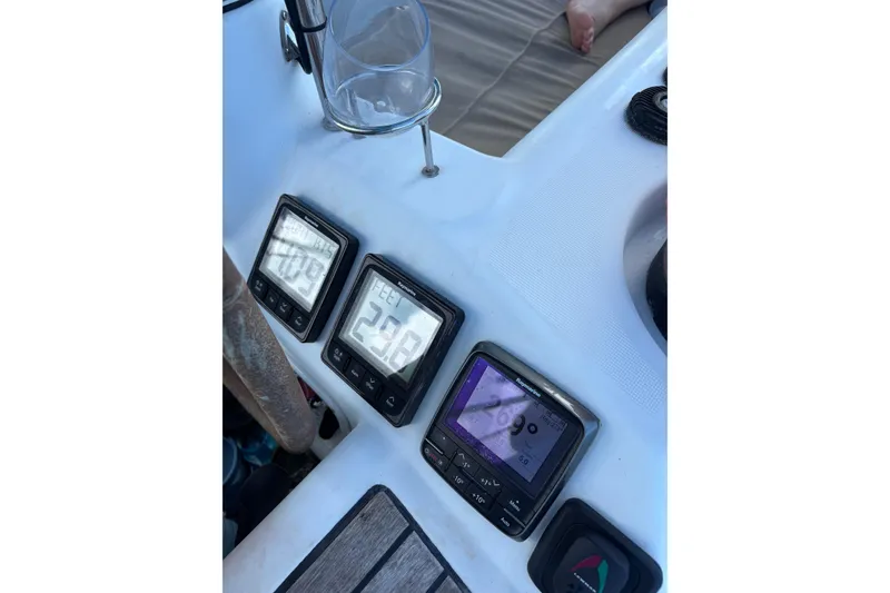 Slide: The Image of Beneteau Oceanis 46 cockpit instruments, 2010 model, displaying navigation data with a glass holder nearby. - 10