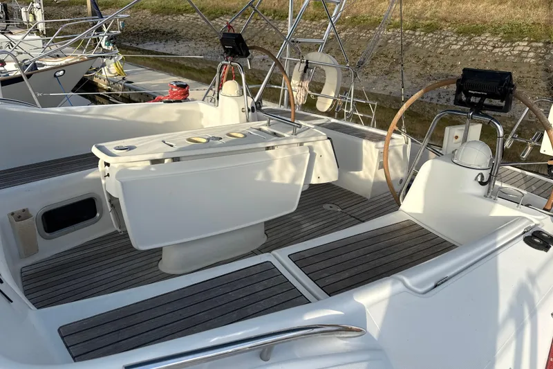 Slide: The Image of Cockpit of 2010 Beneteau Oceanis 46 sailboat with dual steering wheels and teak flooring. - 16