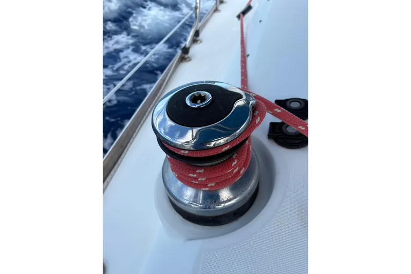 Slide: The Image of Winch on 2010 Beneteau Oceanis 46 sailboat with red rope, ocean in background. - 17