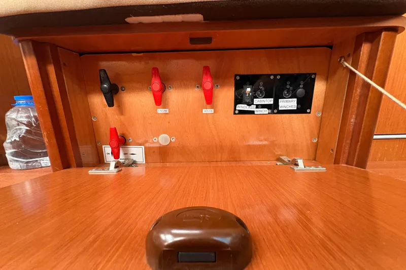 Slide: The Image of Control panel of a 2010 Beneteau Oceanis 46 sailboat with labeled switches. - 32