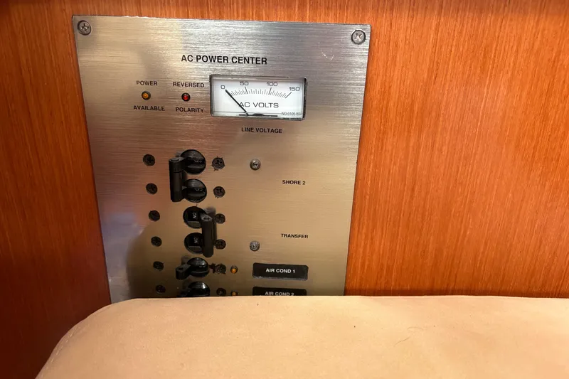 Slide: The Image of AC power center panel on 2010 Beneteau Oceanis 46 yacht, showing voltage meter and switches. - 33