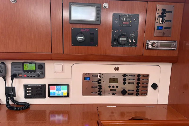 Slide: The Image of Control panel of a 2010 Beneteau Oceanis 46 yacht, featuring navigation and communication equipment. - 37