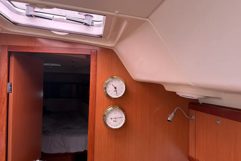 Slide: The Image of Interior of 2010 Beneteau Oceanis 46 yacht with wooden paneling and gauges. - 38