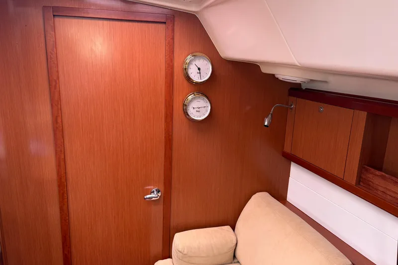Slide: The Image of Interior of 2010 Beneteau Oceanis 46 yacht with wooden paneling and nautical instruments. - 39