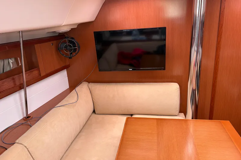 Slide: The Image of Interior of 2010 Beneteau Oceanis 46 yacht with beige seating and wall-mounted TV. - 40