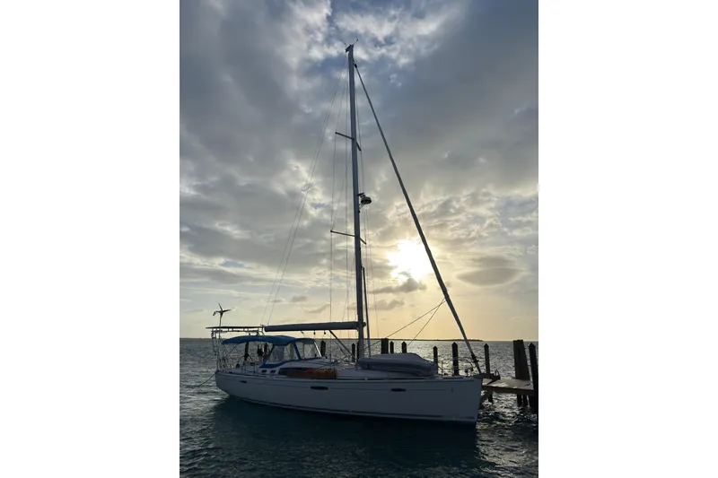 Slide: The Image of Sailboat Beneteau Oceanis 46, 2010 model, docked at sunset with cloudy sky. - 6
