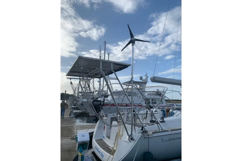 Slide: The Image of 2010 Beneteau Oceanis 46 sailboat docked, featuring solar panels and wind turbine. - 7