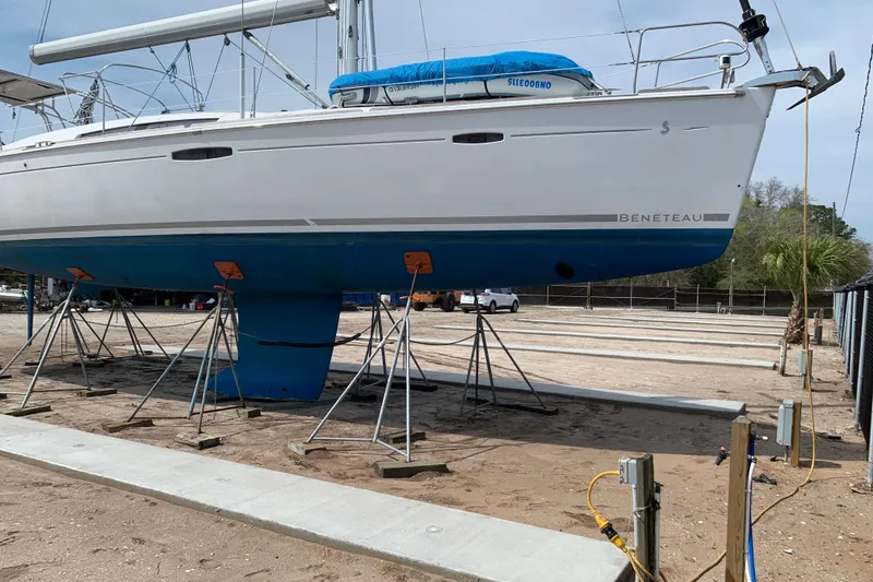 Slide: The Image of Sailboat Beneteau Oceanis 46, 2010 model, on dry dock with blue hull. - 9