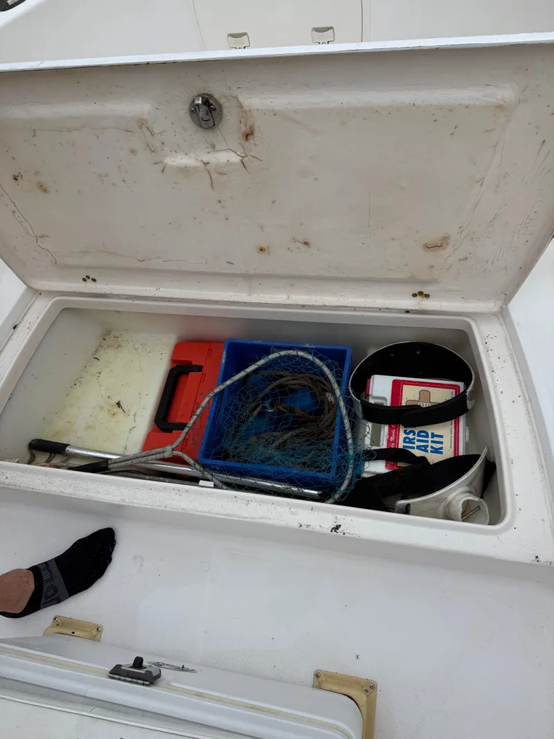 Slide: The Image of Storage compartment of a Wellcraft 212 Fisherman boat with fishing gear. - 5