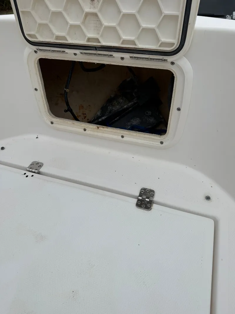 Slide: The Image of Open storage compartment on a 2005 Wellcraft 212 Fisherman boat. - 7