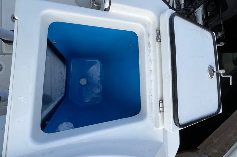 Slide: The Image of Livewell compartment on a 2019 Blackfin 272 CC boat, featuring a blue interior. - 38