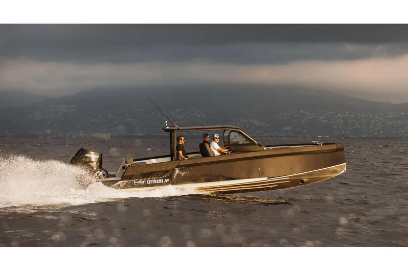 Slide: The Image of Sleek 2027 XO DFNDR A8 boat cruising on open water under cloudy skies. - 6