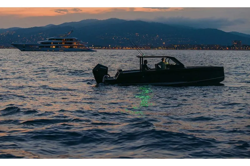 The Image of Boat cruising at sunset, featuring 2027 XO DFNDR A8, with city lights in the background. - 8
