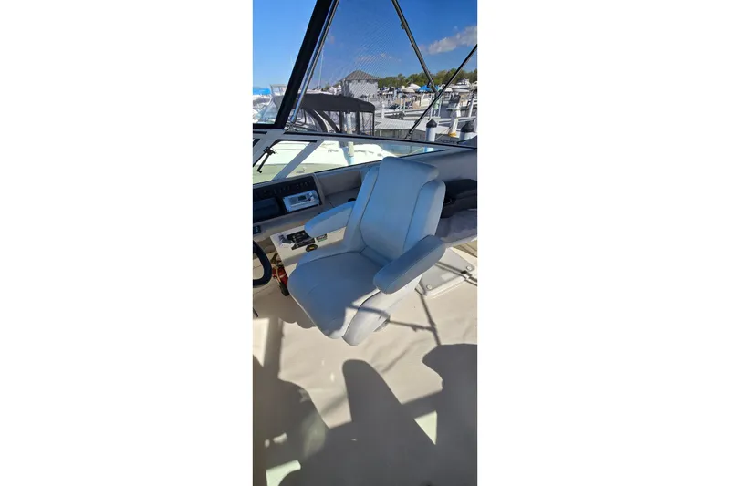 Slide: The Image of Captain's chair on 2006 Carver 36 Mariner yacht, overlooking marina. - 11