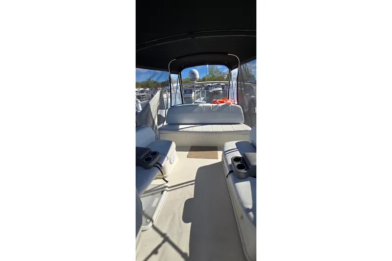 Slide: The Image of Interior view of 2006 Carver 36 Mariner boat with seating and cup holders. - 12