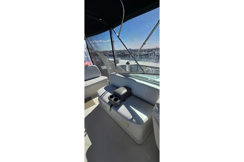Slide: The Image of 2006 Carver 36 Mariner boat interior with seating and cup holders, dock view. - 13