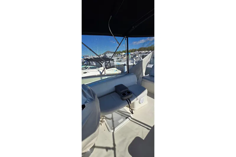 Slide: The Image of 2006 Carver 36 Mariner interior with seating and marina view. - 14