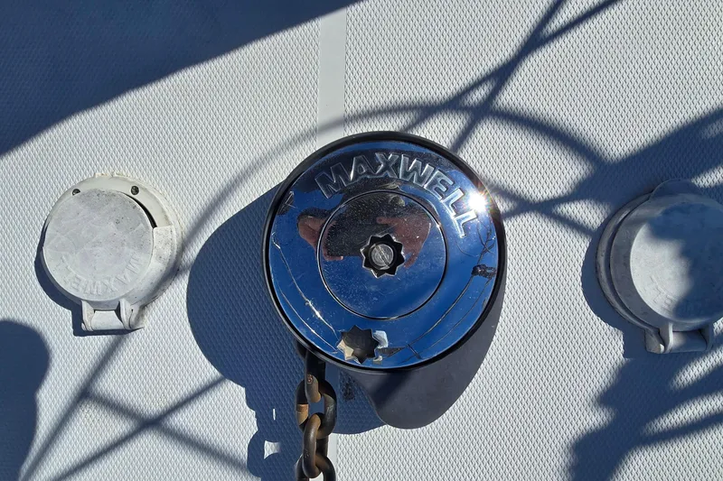 Slide: The Image of Maxwell winch on 2006 Carver 36 Mariner boat deck, with chain and shadows. - 18
