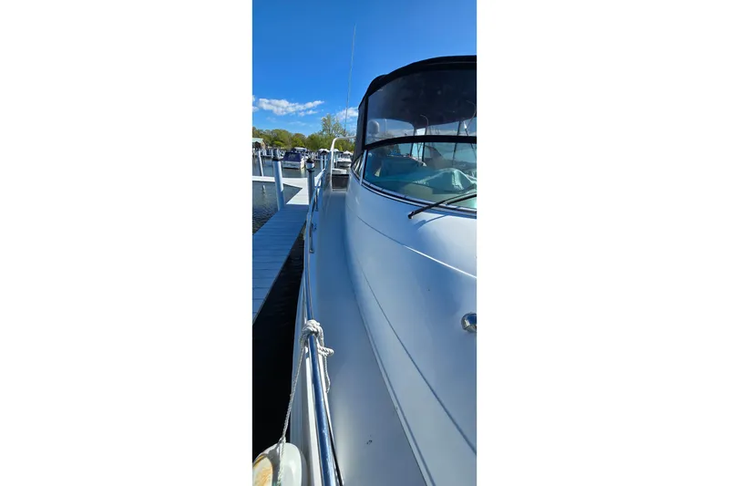 Slide: The Image of 2006 Carver 36 Mariner yacht docked at marina under clear blue sky. - 21