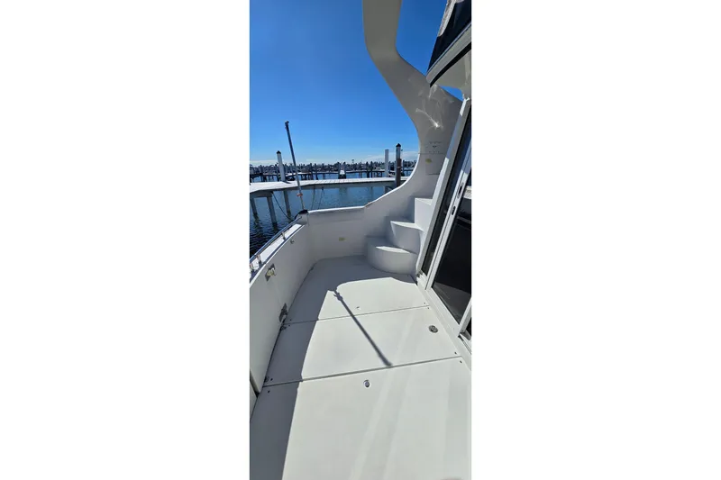 Slide: The Image of 2006 Carver 36 Mariner yacht deck with stairs, overlooking marina. - 23