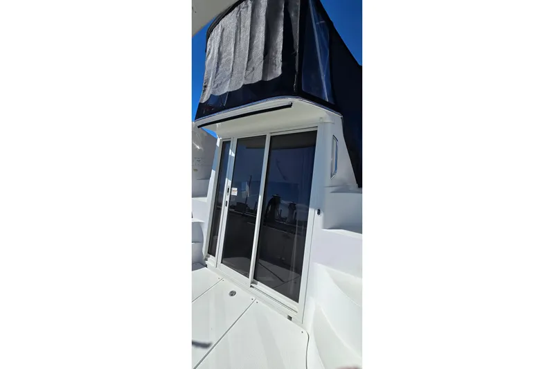 Slide: The Image of 2006 Carver 36 Mariner yacht with sliding glass doors and covered upper deck. - 24