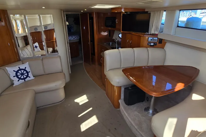 Slide: The Image of Luxurious interior of 2006 Carver 36 Mariner yacht with plush seating and wooden accents. - 26