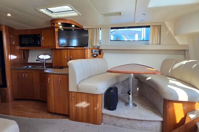 Slide: The Image of Interior of 2006 Carver 36 Mariner yacht with kitchen and dining area. - 28